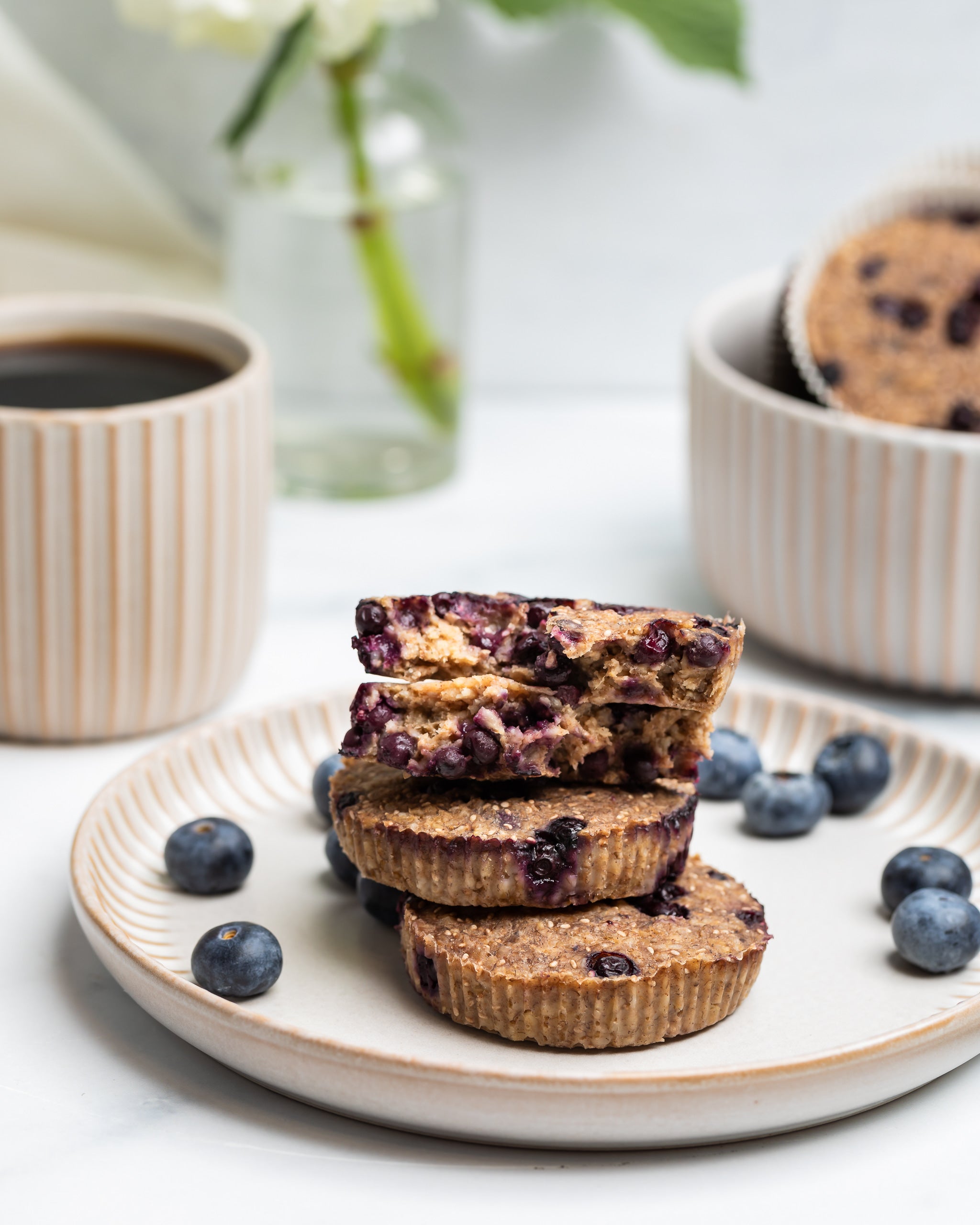 3 wild blueberry OatMEAL Cups stacked on a breakfast plate